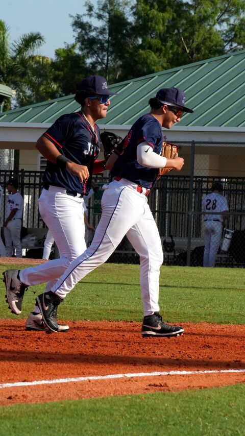 Two players warming up by the field