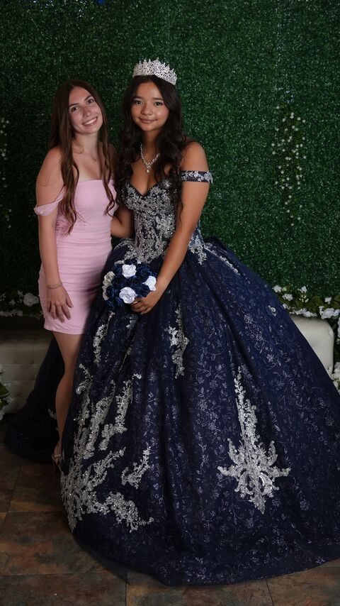 The quinceañera with a guest in a pink dress