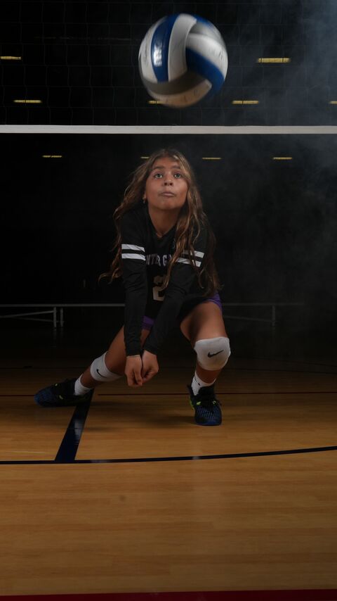 Player in a defensive stance with the ball in the air