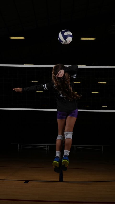 Player jumping to spike the ball