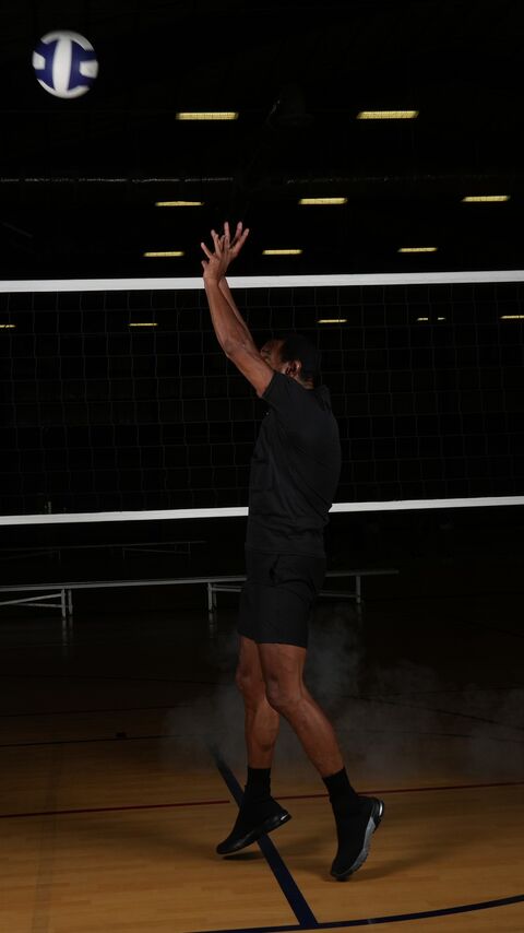 Player in the air with her arm raised