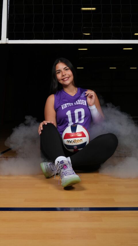 Player sitting on the court floor with the ball
